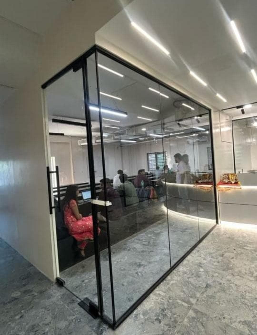 Toughened glass partition for a private office cabin
