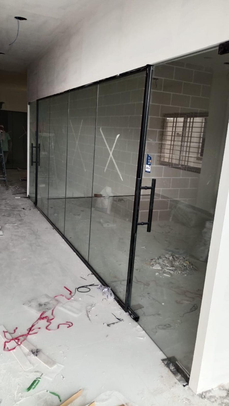Glass cabin partition with a hinged door in an office