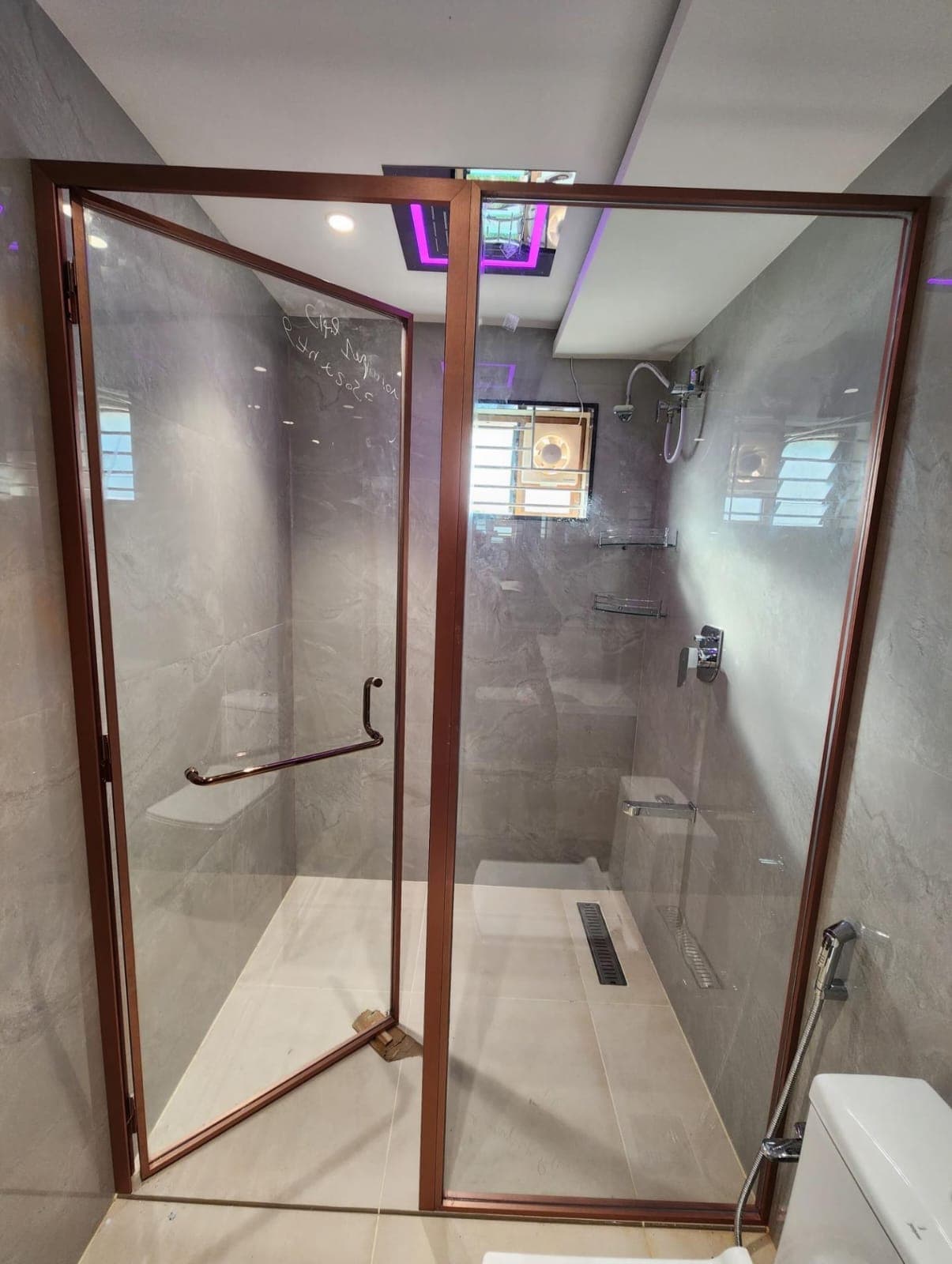 Slim-profile shower partition with a hinged glass door