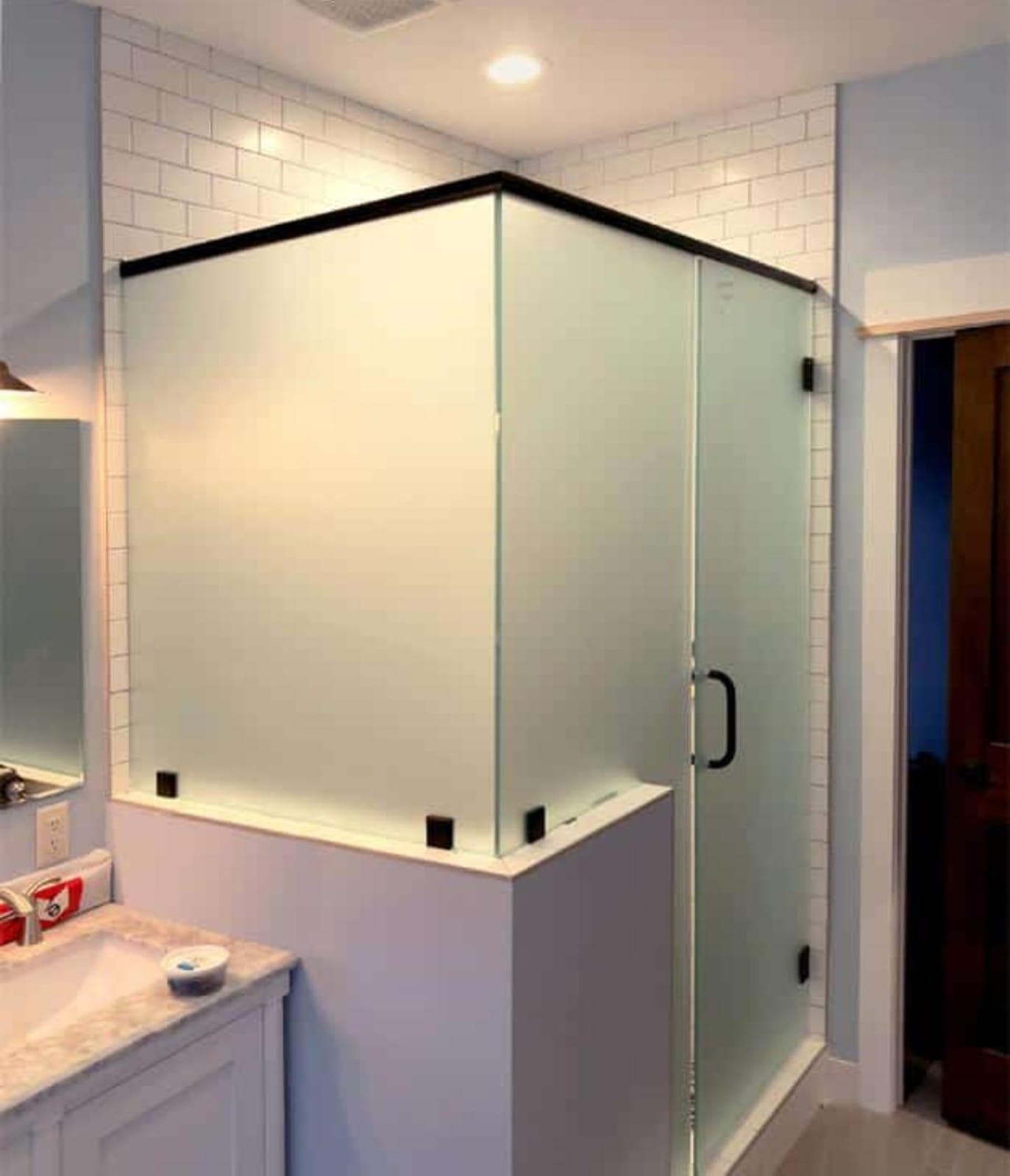 Sliding glass shower enclosure with a clean, sealed edge